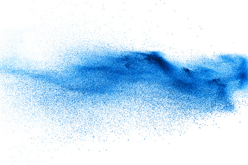 Blue color dust particles splash on white background.