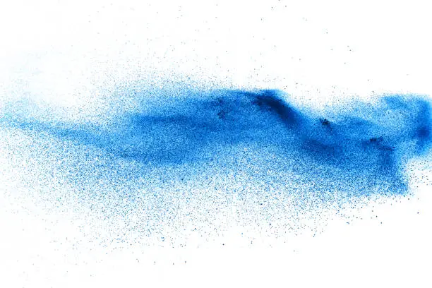 Photo of Blue color dust particles splash on white background.