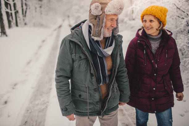 istock Senior couple enjoy walking on the snow 1032071698