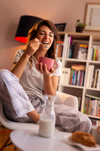 istock Woman eating breakfast cereals 1032076342
