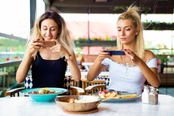 istock Woman's hands photograph her meal with her mobile phone 1032082334