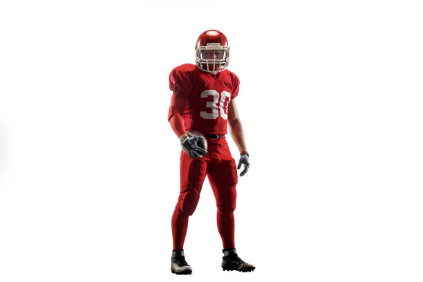 one american football player man studio isolated on white background Active one american football player isolated on white background. Fit caucasian man in uniform posing over studio background. Human emotions and facial expressions concept american football player studio stock pictures, royalty-free photos & images