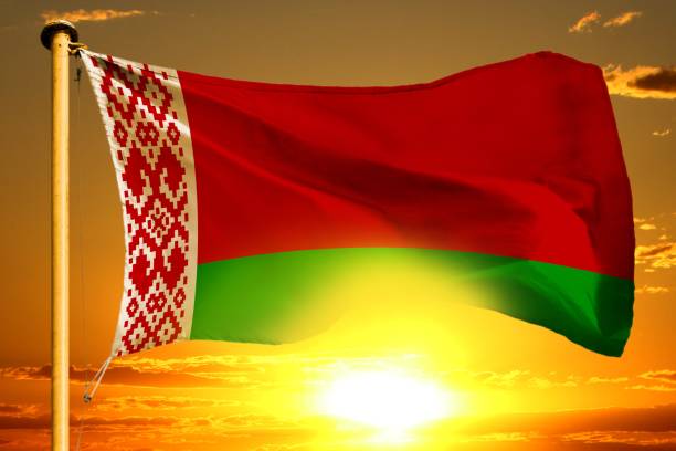 istock Belarus flag weaving on the beautiful orange sunset with clouds background 1032098692