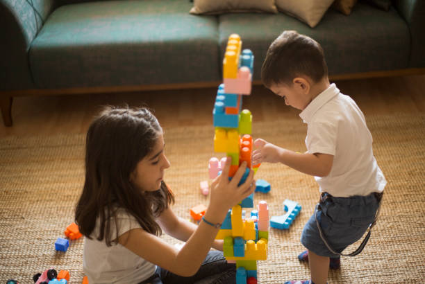 istock Two children playing with toy blocks. 1032103342
