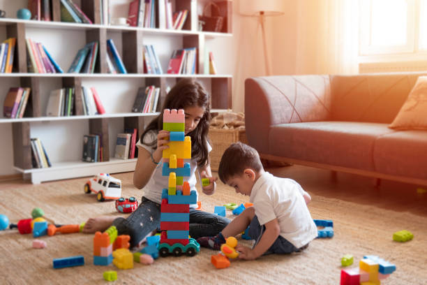 Two children playing with toy blocks.