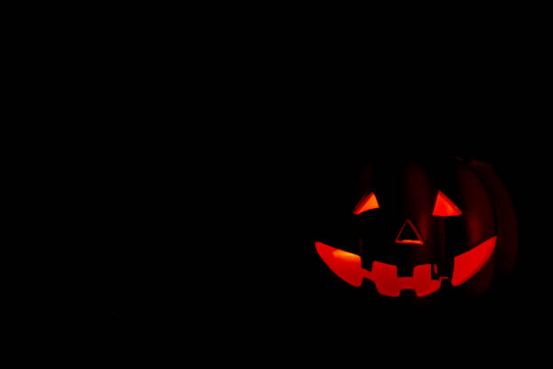 istock Pumpking iluminated on the darkness. Halloween cocept 1032110840