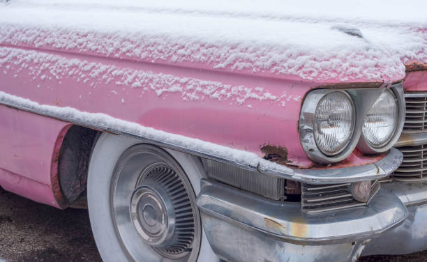 A 1970's coupe is inundated with snow.