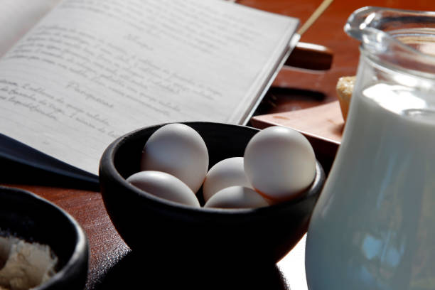 cookbook, eggs and milk - chef cookie dishware domestic kitchen imagens e fotografias de stock