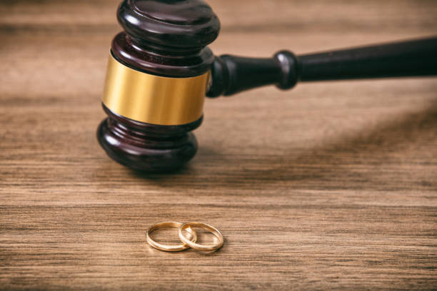 istock Wedding rings and judge gavel on wooden background, copy space 1032112020