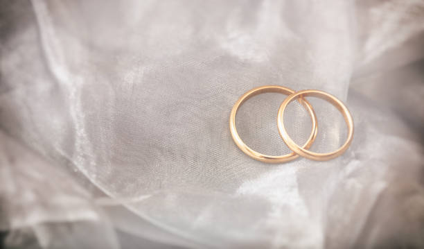 istock Two golden wedding rings on white silver background, copy space 1032112112