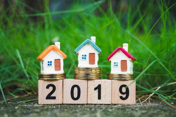 istock Miniature colorful house on golden stack coins 1032117752