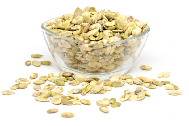 istock raw pumpkin seeds kernels in bowl on white background 1032132424