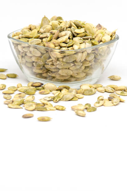 istock raw pumpkin seeds kernels in bowl on white background 1032132426