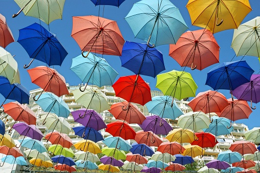 texture set of open colored umbrellas on blue sky background