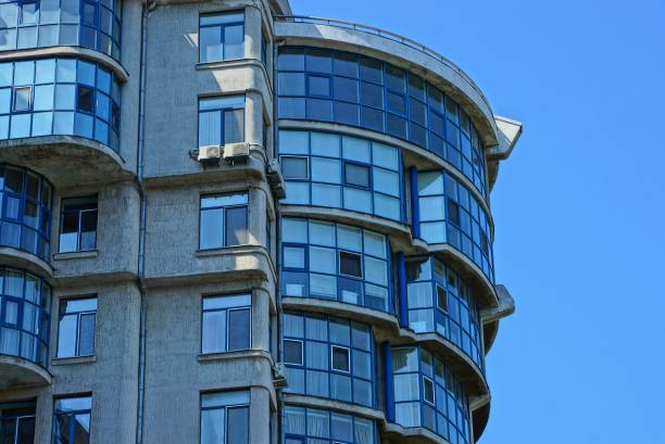 istock part of a high gray house with windows and balconies against the blue sky 1032139708