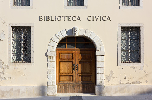 Entrance of the historic public library in Gradisca d'Isonzo, Italy