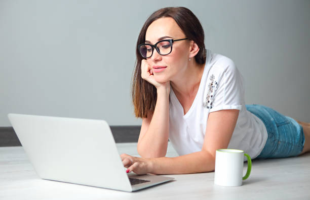 istock Young woman with computer indoors 1032143858