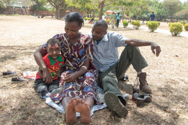 Family takes a rest in city Uhuru Park in Nairobi, Kenya. stock photo