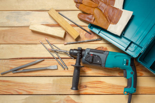 istock Electric hammer drill lies on a wooden table 1032149888