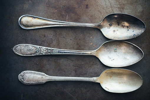 Antique utensils background. Silver spoon. Silverware.