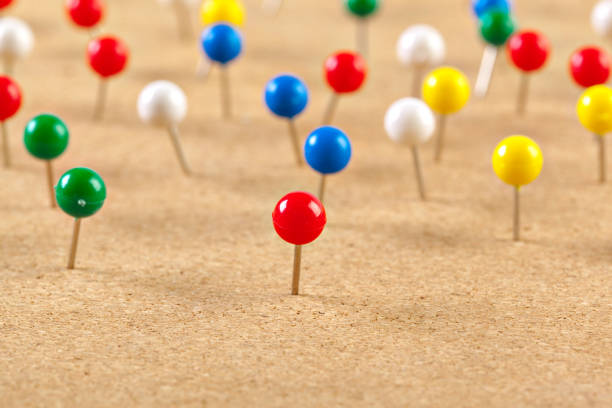 istock Group of thumbtacks pinned on corkboard 1032162198