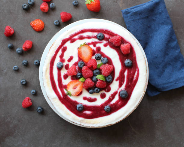Cheesecake with berries on top and coulis