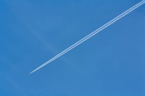 istock Trace of an airplane against blue sky. 1032165554