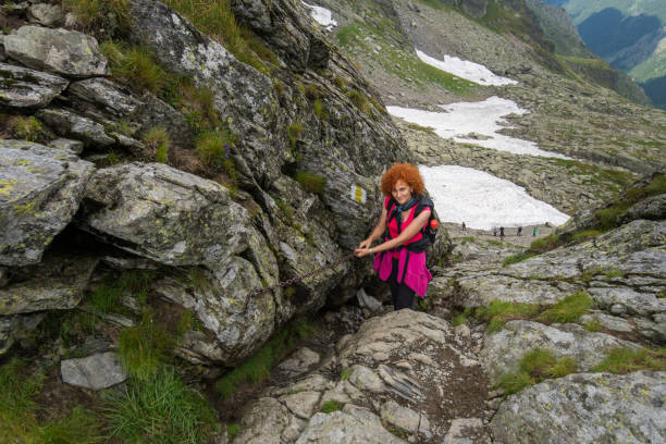 istock Woman hiking into rocky mountains 1032169926