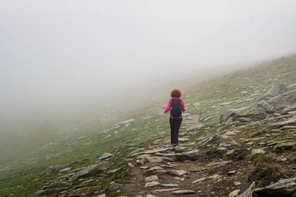istock Woman hiking into rocky mountains 1032173074