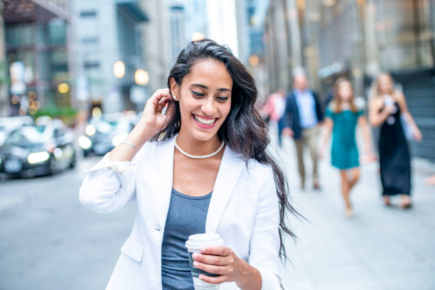istock Professional woman smiling while walking in the city 1032173350