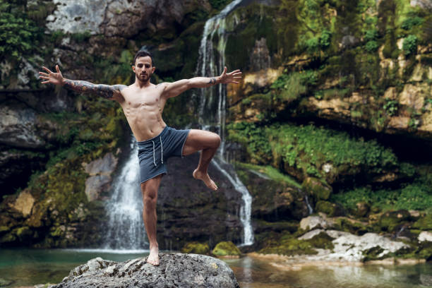 Yoga Man practicing yoga in nature man yoga tattoo stock pictures, royalty-free photos & images