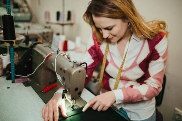 istock Young woman sewing and making clothes in the workshop 1032184344