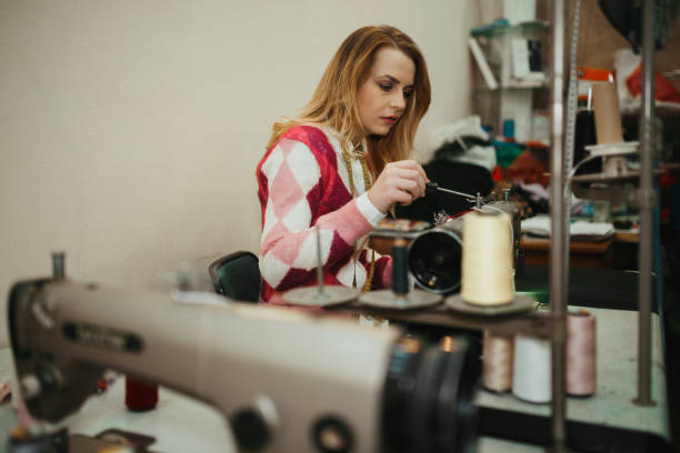 istock Young woman sewing and making clothes in the workshop 1032184552