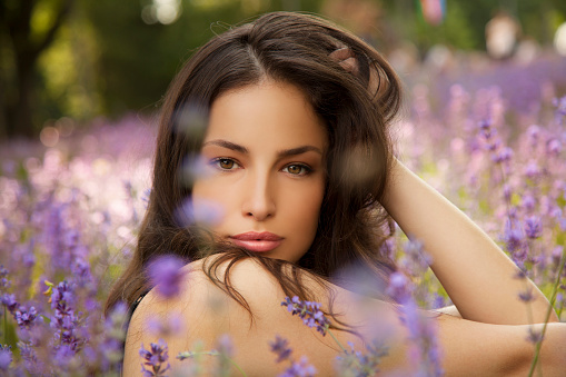 beautiful young woman in lavender field, outdoor closeup portrait