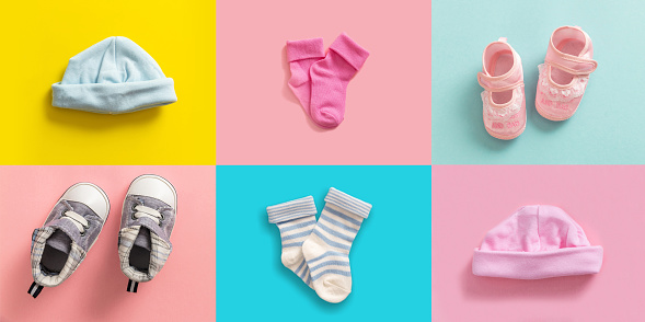 Twins babies shower concept. Baby boy and girl shoes and socks collage, pastel colored background