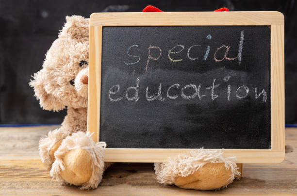 Special education. Teddy bear hiding behind a blackboard. Special education text drawing on the blackboard