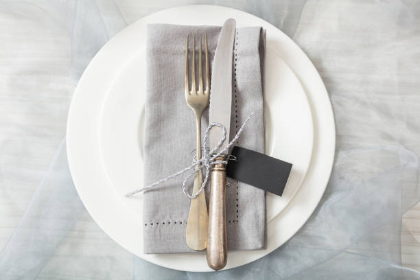 istock Holiday table place setting with plates, fork and knife, top view 1032189404