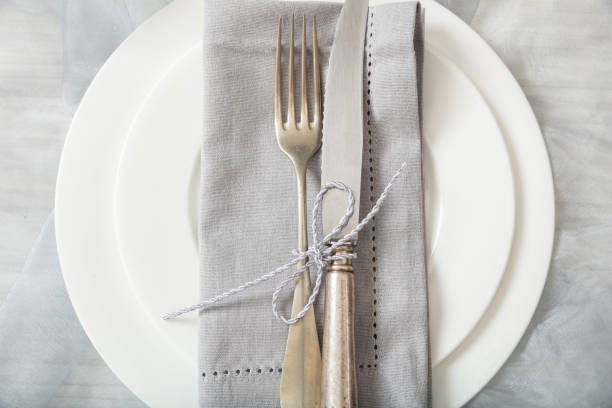 istock Holiday table place setting with plates, fork and knife, top view 1032189416