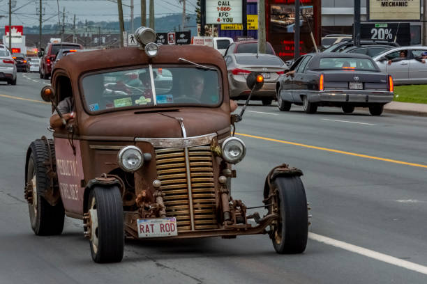 Rat Rod - 1940 Chevrolet truck 2016 Atlantic Nationals Automotive Extravagnaza, Moncton, New Brunswick, Canada - July 9, 2016. A rat rod based upon a 1940 Chevrolet fire truck cruises Mountain Road, Saturday evening July 9, 2016. cruising hot rods stock pictures, royalty-free photos & images