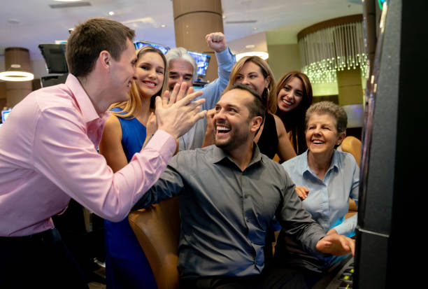 istock Excited group celebrating with a guy who hit jackpot on slot machine 1032204108