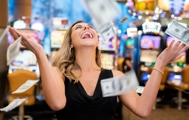 Cheerful beautiful woman excited about all the money she won at the casino throwing to the air Cheerful beautiful woman excited about all the money she won at the casino throwing to the air very happy Gambling women stock pictures, royalty-free photos & images