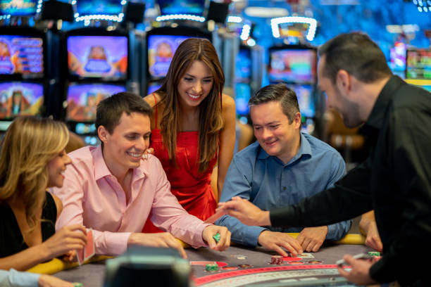 istock Group of friends having fun at the blackjack table gambling 1032204334