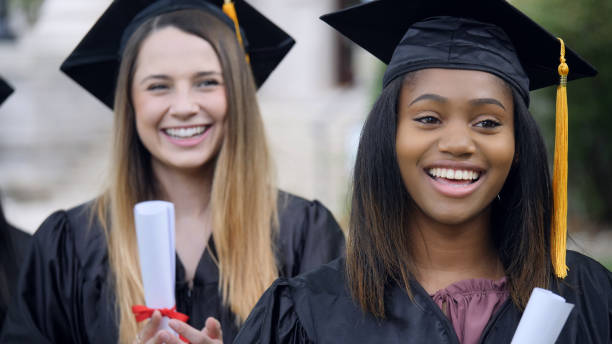 istock Female college students smile during graduation ceremony 1032209618
