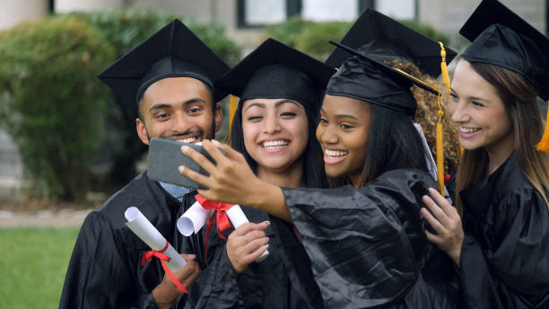 istock College grads taking selfie together 1032209642