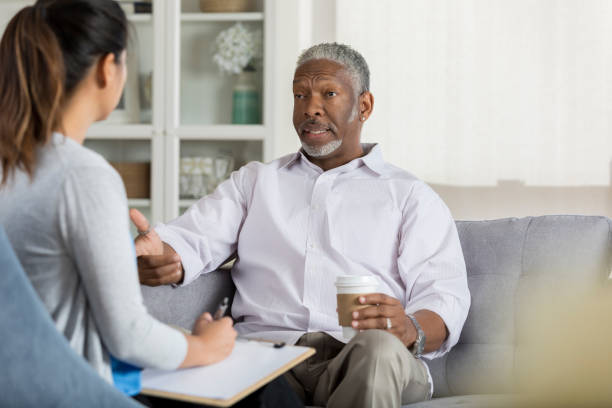 Senior man speaks openly with attentive therapist