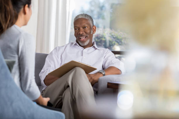istock Senior male therapist speaks with unrecognizable client 1032209870
