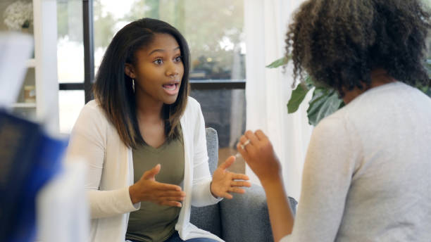 Teenage girl with attitude argues with mom Upset teenage girl gestures while having an intense argument with her mother. confrontation stock pictures, royalty-free photos & images