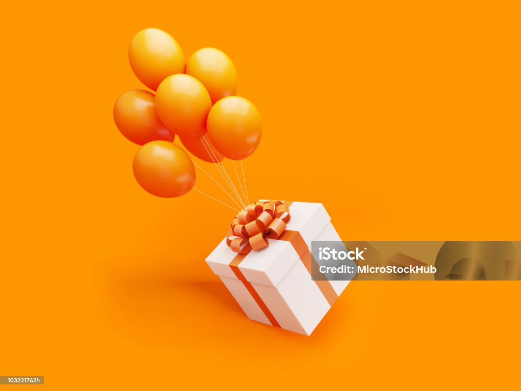 La confezione regalo bianca legata con nastro arancione è portata via da palloncini di colore arancione - Foto stock royalty-free di Regalo