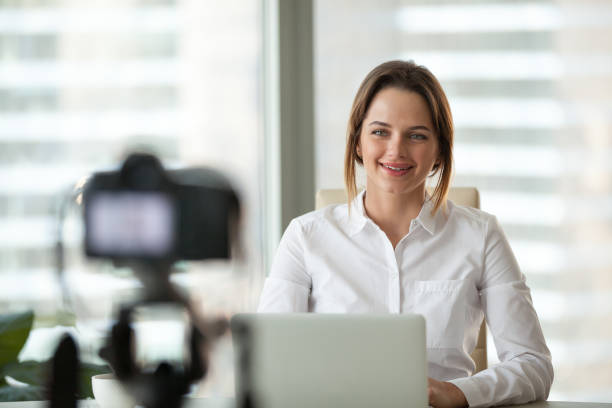istock Confident businesswoman recording video course on camera 1032228812