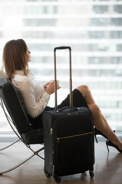 istock Thoughtful female drinking coffee waiting for flight in airport 1032228860